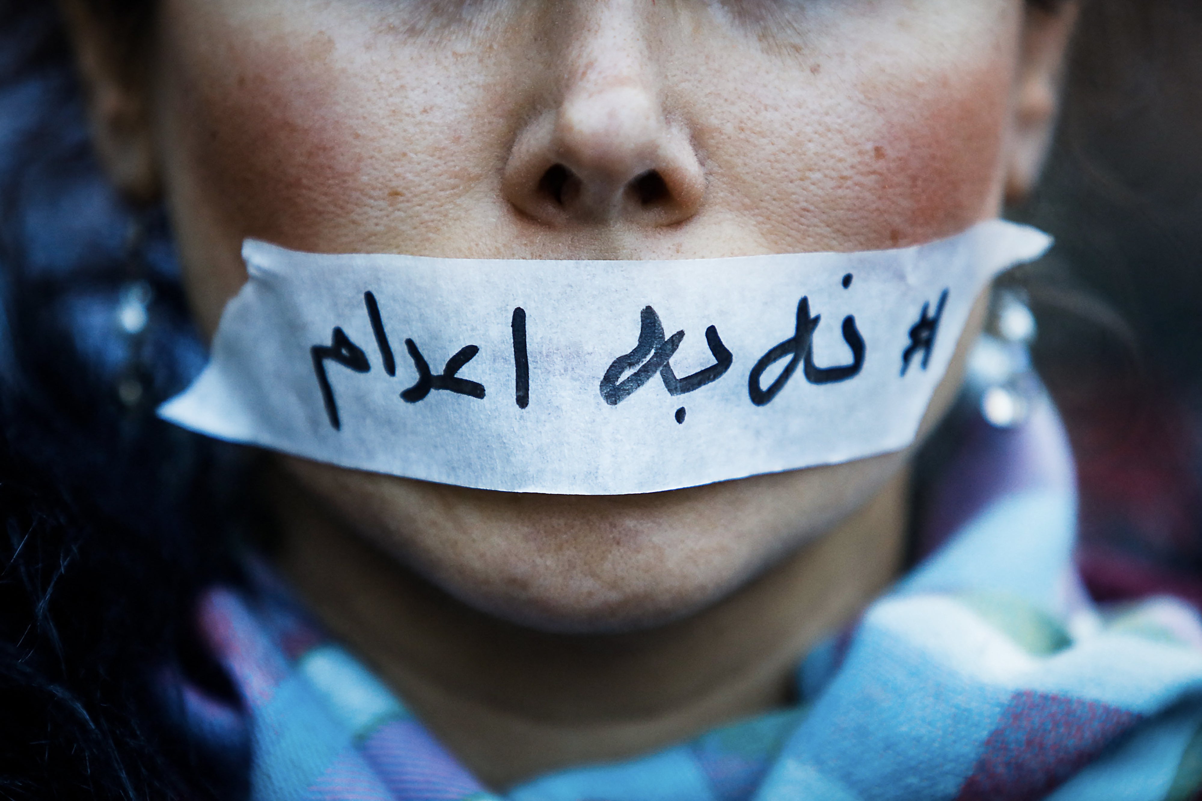A person's mouth covered with tape bearing a message “no to executions” in Iran, in Paris in France, January 31, 2026.