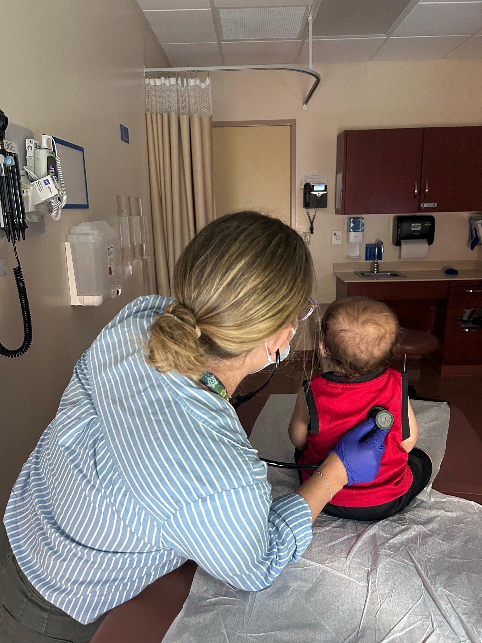 A pediatrician at a health center in Los Angeles providing healthcare services to immigrant families. 