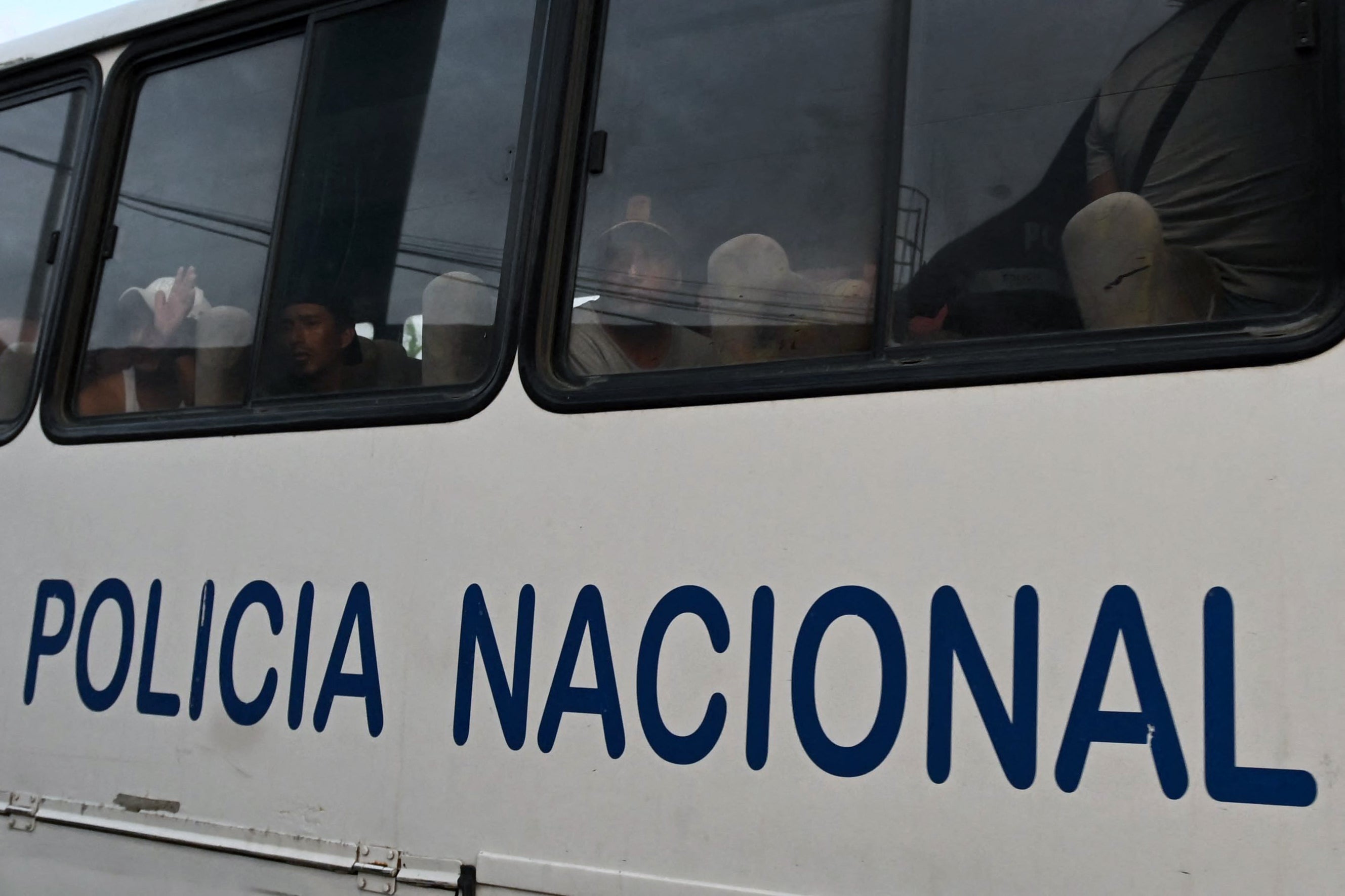 A group of detained fishermen are transported on a National Police bus to the Community Surveillance Unit (UVC) from the port of Manta, Ecuador, on September 4, 2026.