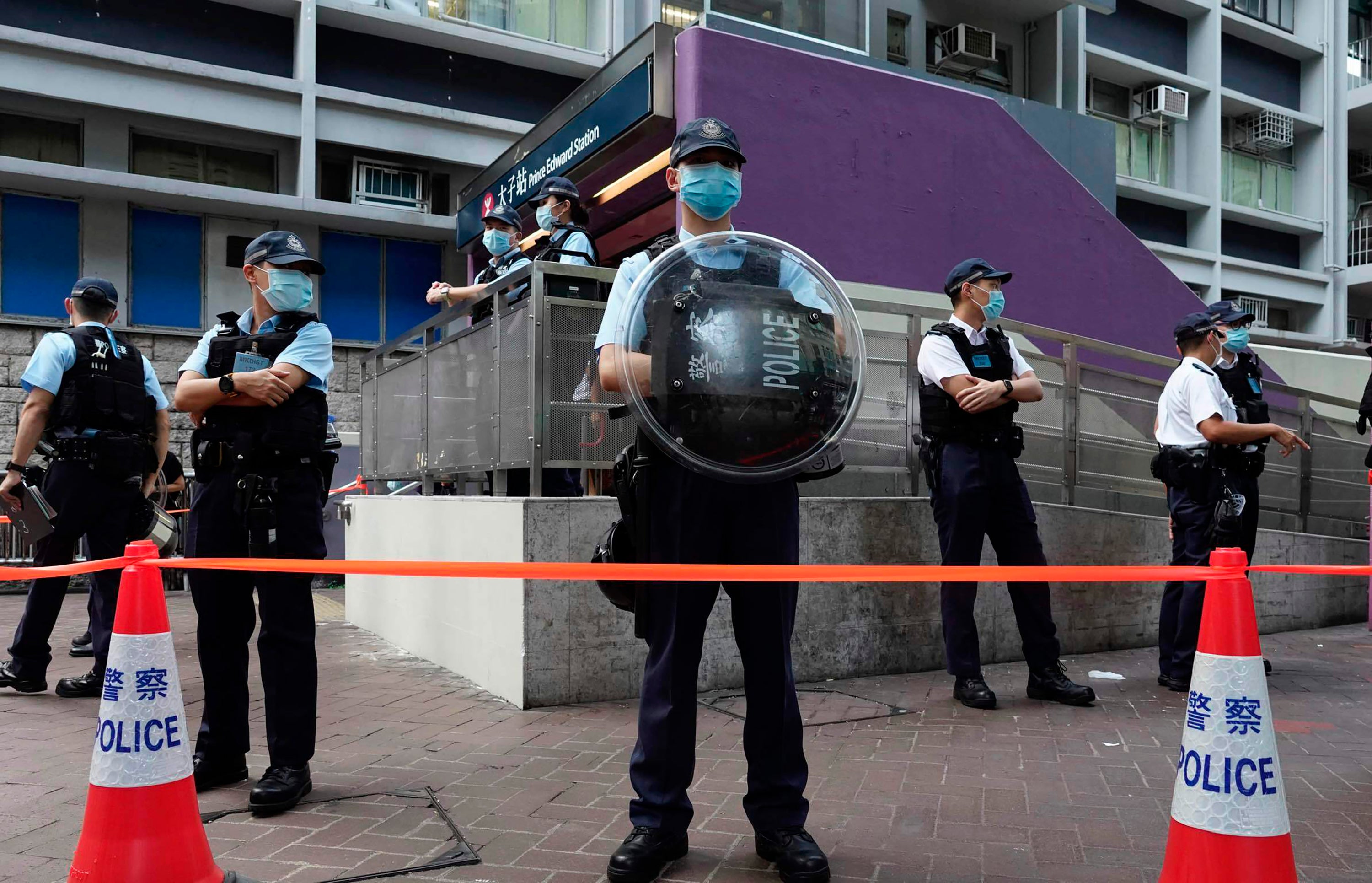 Police officers stand guard outside the Prince Edward subway station