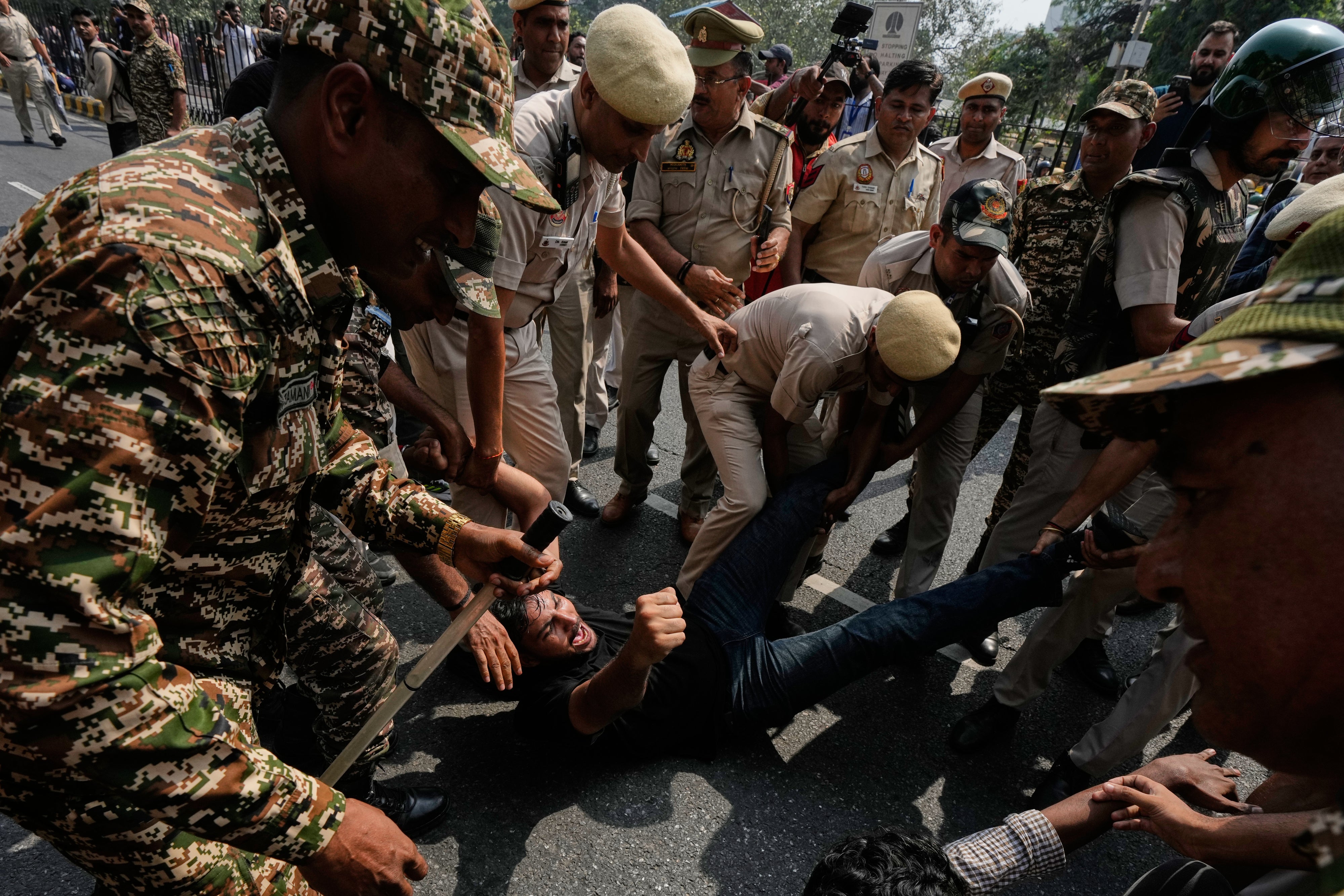 Police detain protesters during a demonstration 