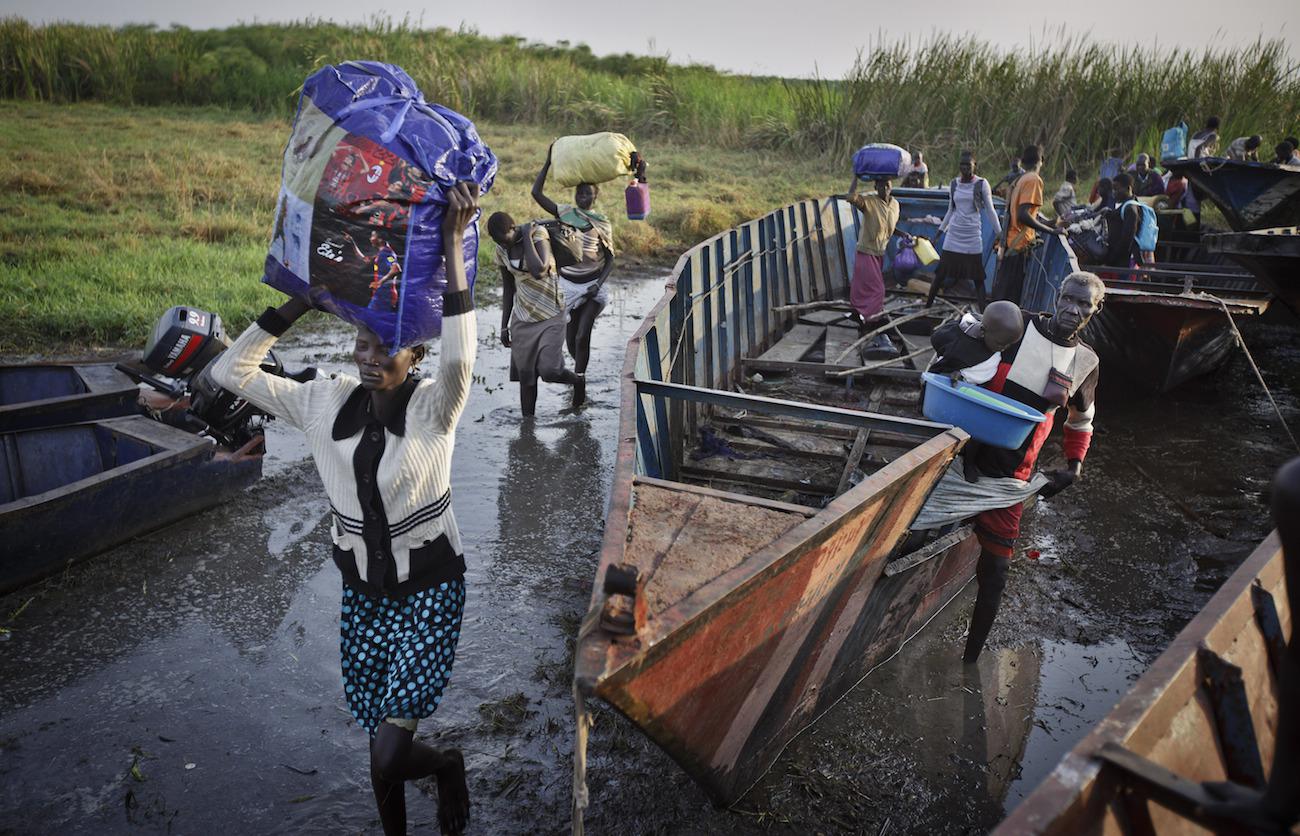 Displaced people arrive in Awerial, Lakes State, by river barge from Bor town in December 2013. 