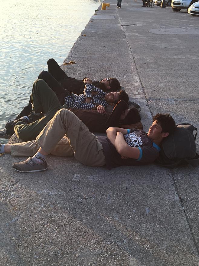 Afghan youth rest at the Lesbos harbor after walking 30 hours from the point where their boat reached land. 