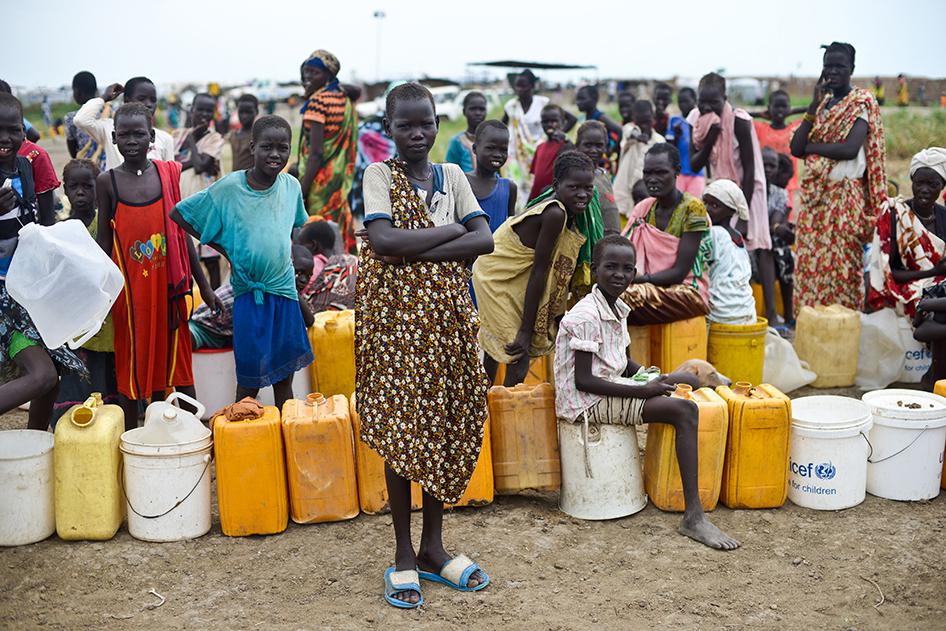 Girls waiting in line for water in the UNMISS camp near Bentiu. As of the end of June, the camp had registered about 81,000 inhabitants, including at least 28,000 new arrivals in April and May who now reside in mostly cramped and unsanitary conditions. 