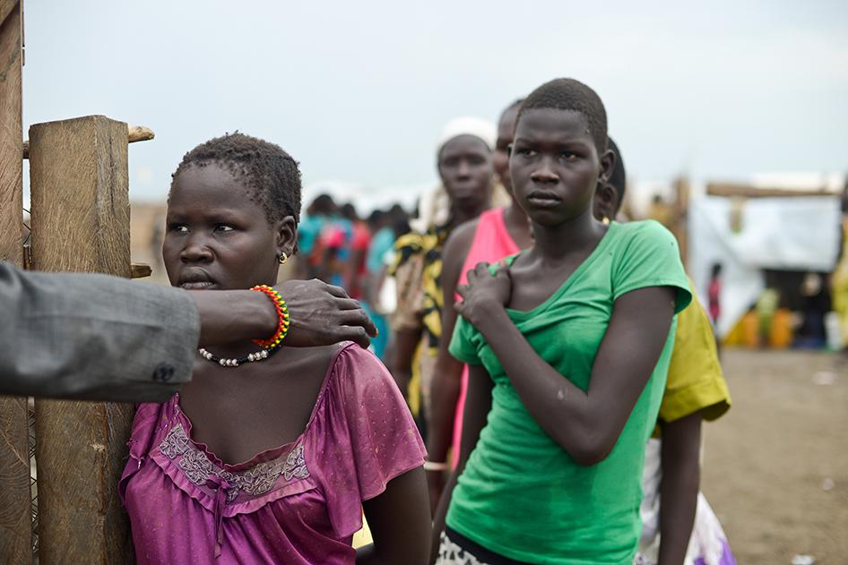 A woman at the front of a line for water in the UNMISS camp near Bentiu is directed to an enclosed water pumping area where demand is high and women must wait in long lines, sometimes for hours even before dawn. 