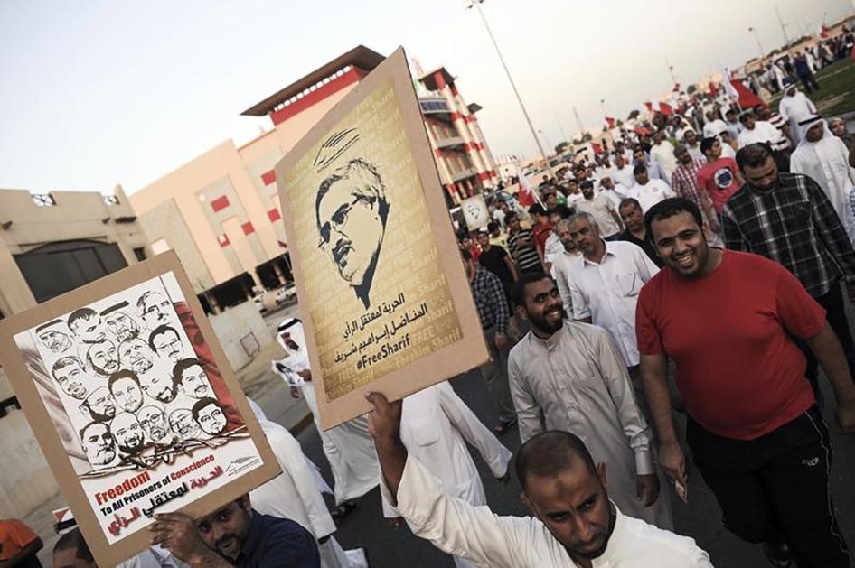 Protesters hold posters with pictures of political activist Ibrahim Sharif and other political prisoners as they march to demand their release during a rally organized by Bahrain's main opposition group Al Wifaq in Al A'aali village, Bahrain on November 1