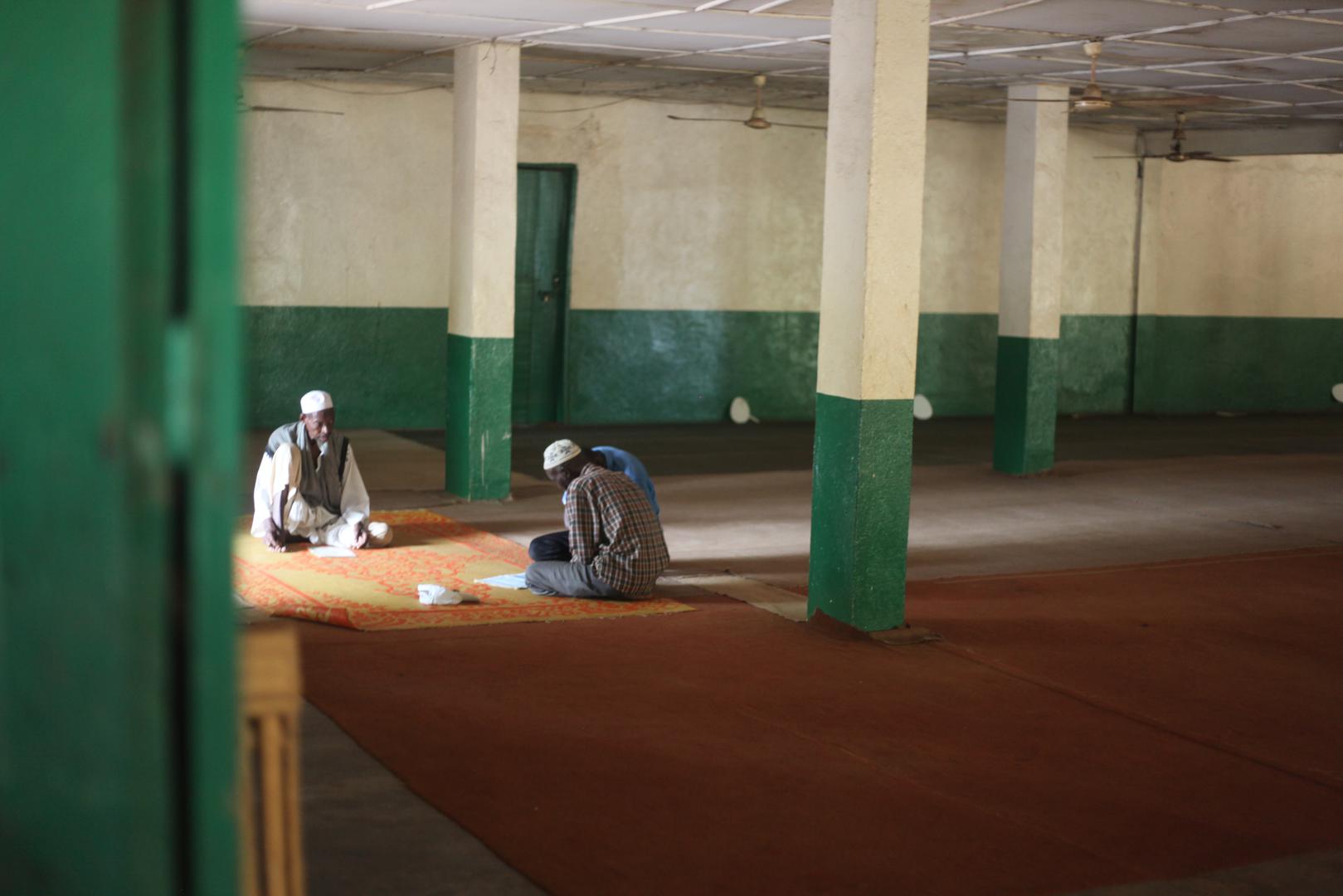 Men praying at the Koudoukou central mosque in the Kilomètre 5 neighborhood of Bangui, CAR. Some 3,000 people sought shelter on the grounds of the mosque after fleeing anti-balaka attacks in January 2014. 