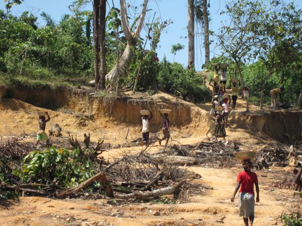 Women and children carry pans of ore at Dompim mining site, Tarkwa-Nsuaem district, Western Region.
