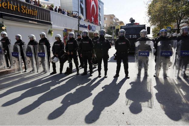 Riot police stand guard outside the Kanalturk and Bugun TV building in Istanbul, 28 October 2015