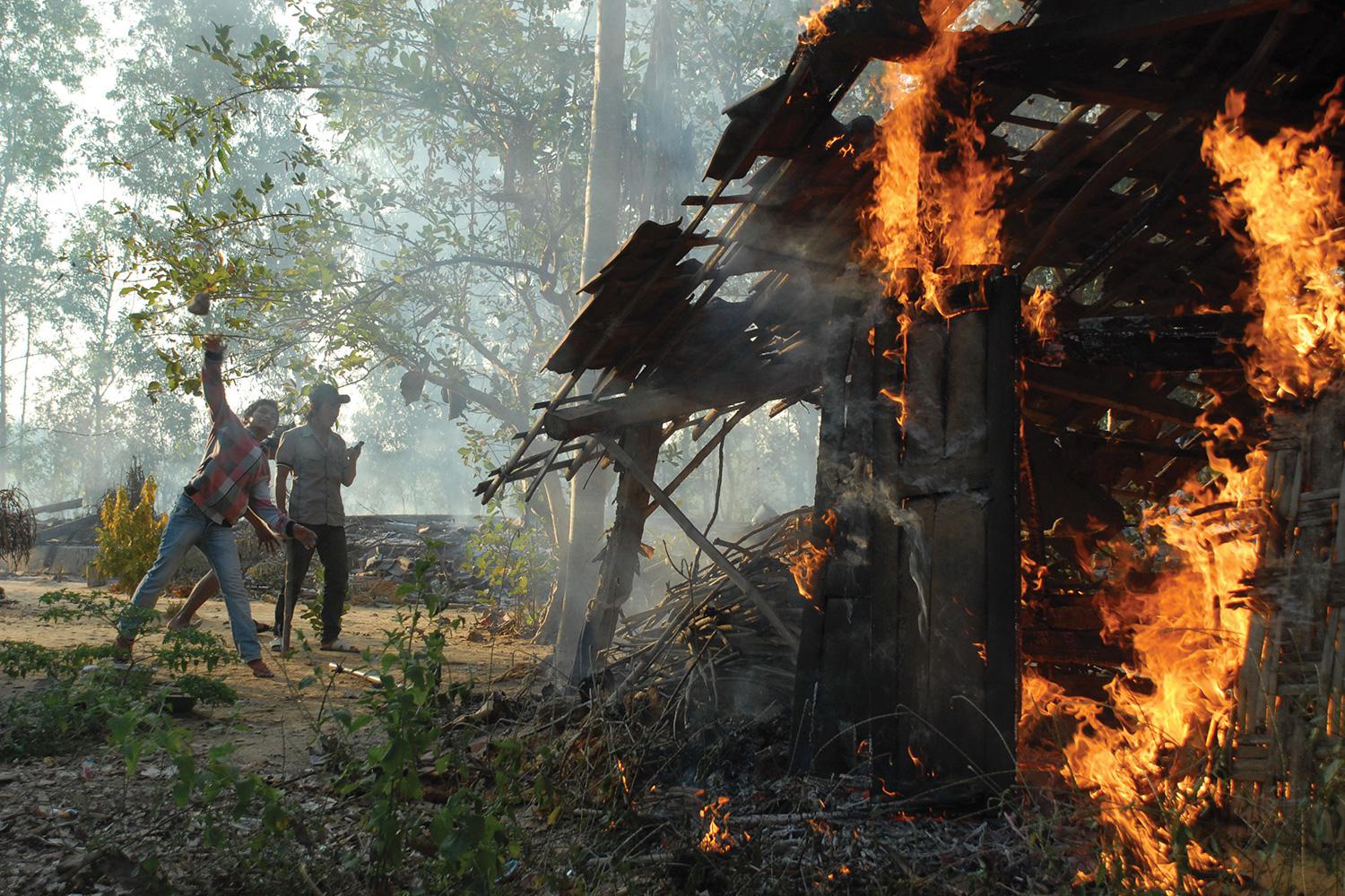  Militants burn down Shia houses on August 26, 2012, in the village of Nangkernang in Sampang regency, Madura Island. Hundreds of Sunni militants associated with the Ulema Consensus Forum torched around 50 Shia homes that day.