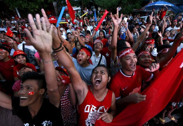 Supporters of Aung San Suu Kyi gather outside National League for Democracy headquarters (NLD) in Rangoon on November 9.