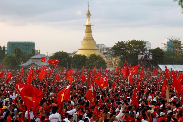 Supporters wave NLD flags after Aung San Suu Kyi gave a speech at her campaign rally in Rangoon.