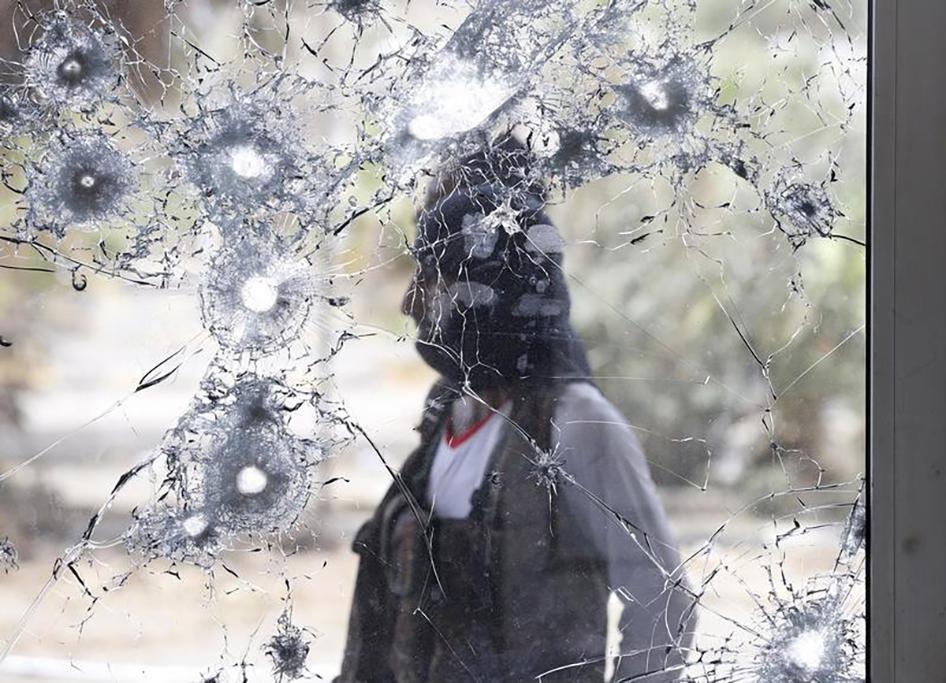 An anti-Houthi fighter stands guard at Aden international airport, which has been badly damaged due to fighting in the city since March 2015, on July 24, 2015 in Aden, Yemen.