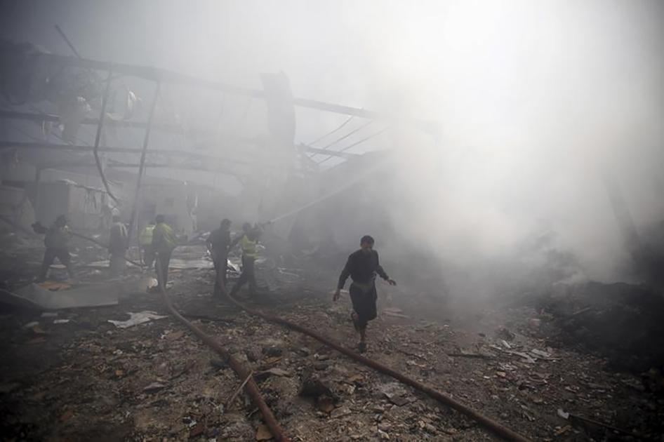 Firefighters extinguish a fire at a food storage warehouse hit by a Saudi-led air strike in Yemen's capital Sanaa on October 25, 2015. 