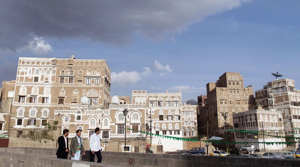 People walk on a bridge in the Old Sanaa city, January 10, 2014. 