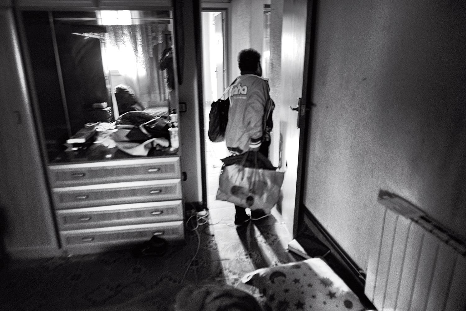 A woman picks up her clothes from her room after receiving an eviction notice in Terrassa, Spain, October 19, 2012.