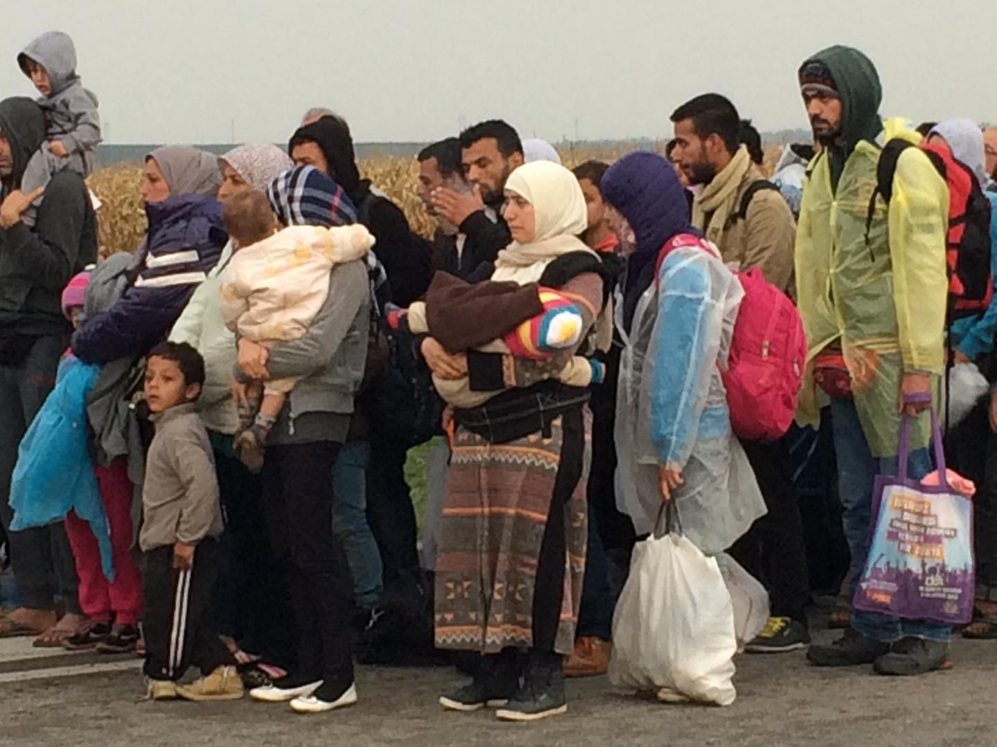 Migrants queuing outside Tovarnik