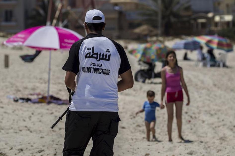A tourist police officer patrols at the beach near the Imperiale Marhaba hotel, which was attacked by a gunman in Sousse, Tunisia on July 1, 2015. 