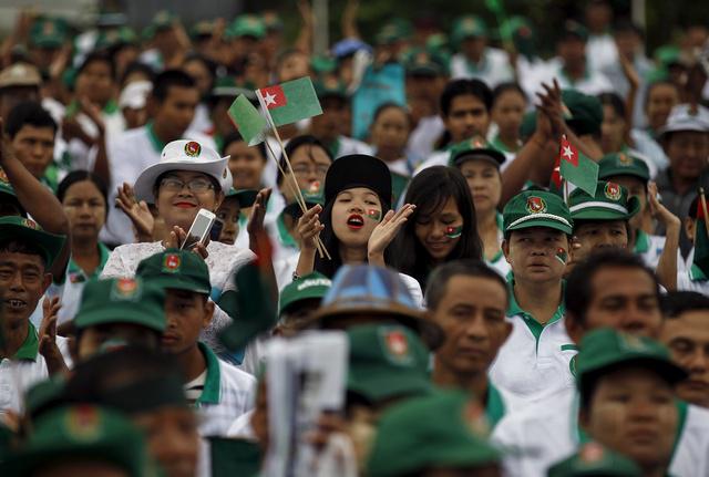 Supporters react during a a ruling Union Solidarity and Development Party (USDP) campaign rally in Rangoon, Burma on October 10, 2015.