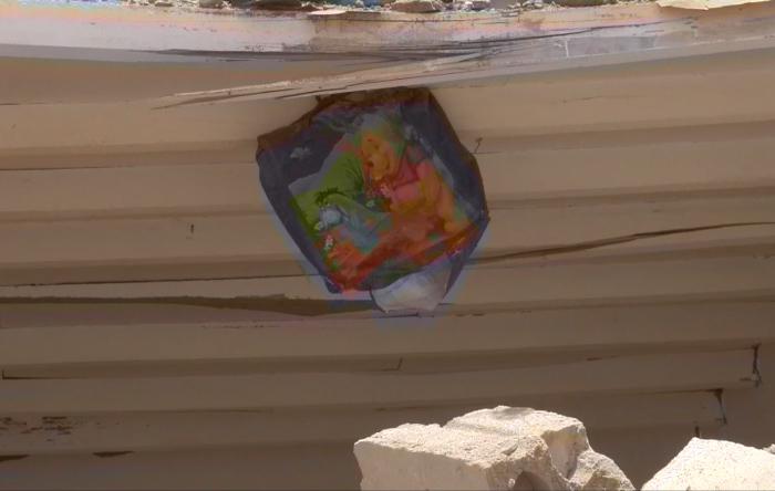A poster of the children’s books characters, Winnie the Pooh and Eeyore, still hanging amid the destruction of the al-Ibbi home. 