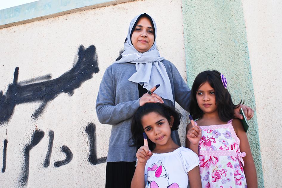 Manal Ameer, 33, pictured here with her two daughters, was among the first to vote in Benghazi.