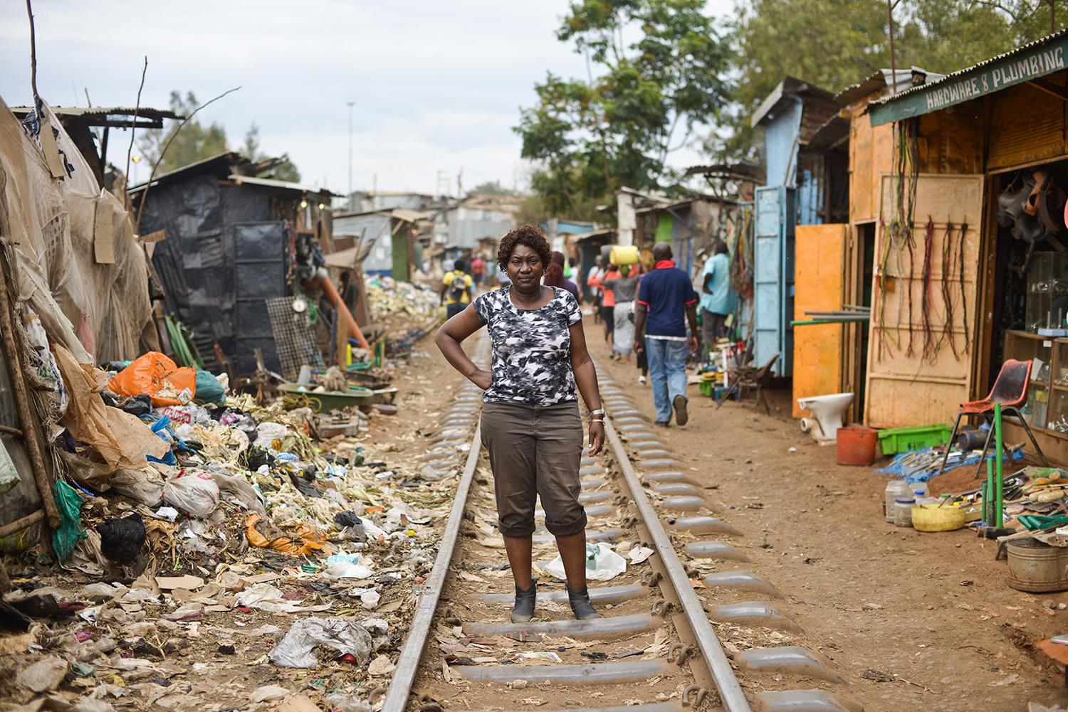 Jaqueline Mutere, 48, walks on a rail line in Kibera, the largest slum in Kenya, which was one of the hotspots of the post-election violence. 