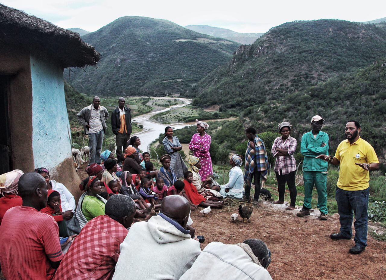 Residents of Mkumbi gather to share stories about chemical spraying.