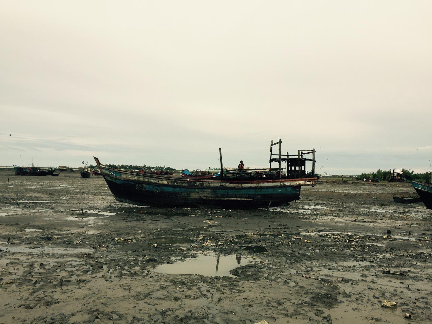 A Rohingya girl sits atop a fishing boat on the outskirts of an IDP camp in Sittwe, Arakan State, Burma, September 2015.