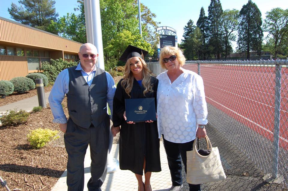 Liz standing between her parents, Ken and Valoyce Luras and for her graduation ceremony from George Fox University. Newburg, Oregon. May 2015