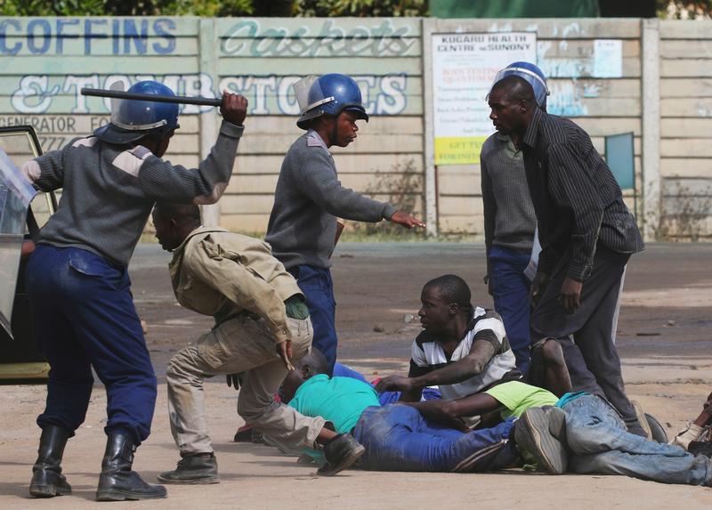 Riot police detain residents of Epworth suburb after a protest by taxi drivers turned violent in Harare, Zimbabwe, July 4, 2016.
