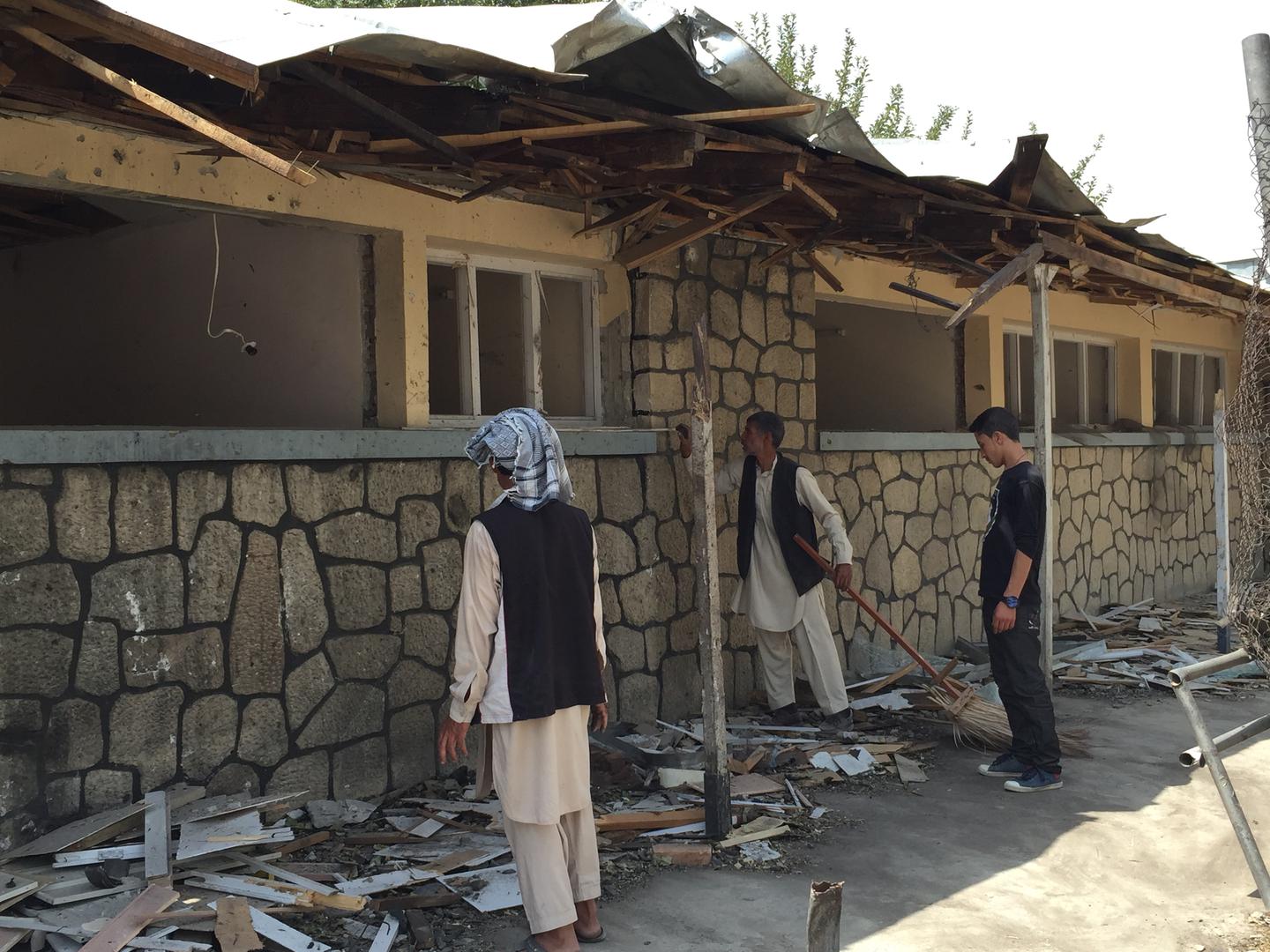 People clean debris at the Vocational High School for the Blind in Kabul, following an attack on August 25, 2016 that left the school closed.