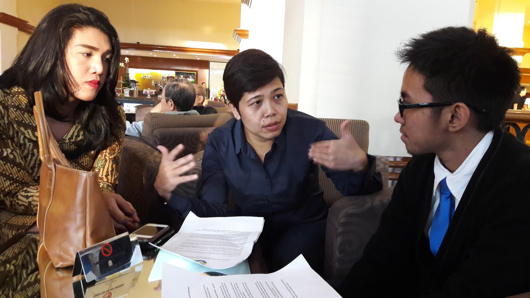 Kanza Vina (left), a transgender woman, talks with Abhipraya Ardiansyah (far right), a transgender man, and Yuli Rustinawati (center), their colleague from Forum LGBTIQ Indonesia. Vina and Abhipraya received awards from an independent journalism union.