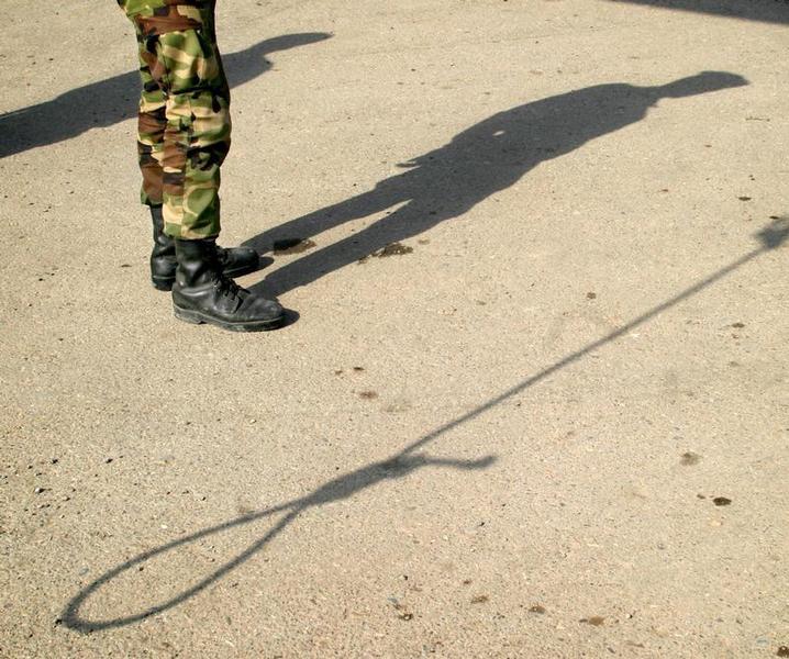 Shadows of an Iranian policeman and a noose are seen on the ground before an execution in Pakdasht, south of Tehran, March 2005.