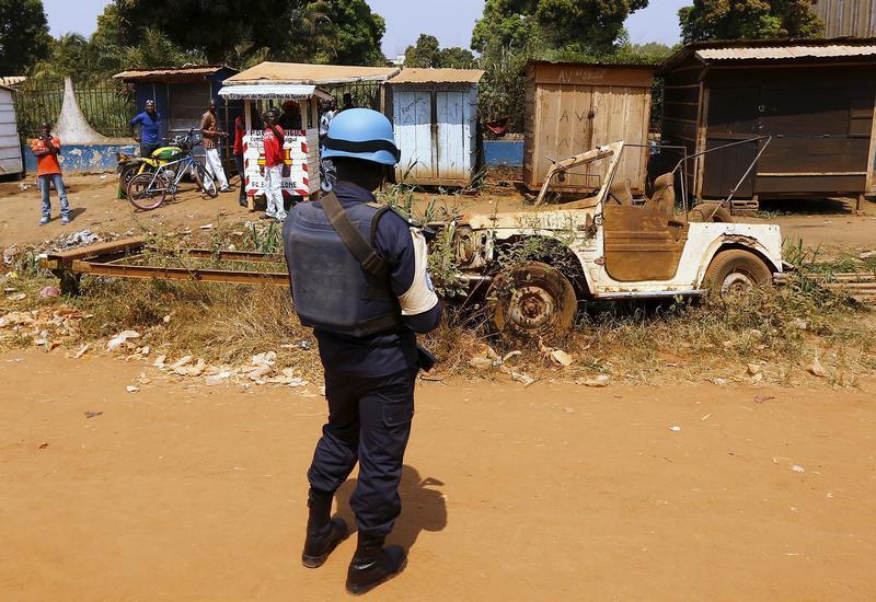 A United Nations peacekeeper stands alongside a road near the refugee camp of Saint Sauveur, in the Central African Republic capital, Bangui, November 29, 2015.