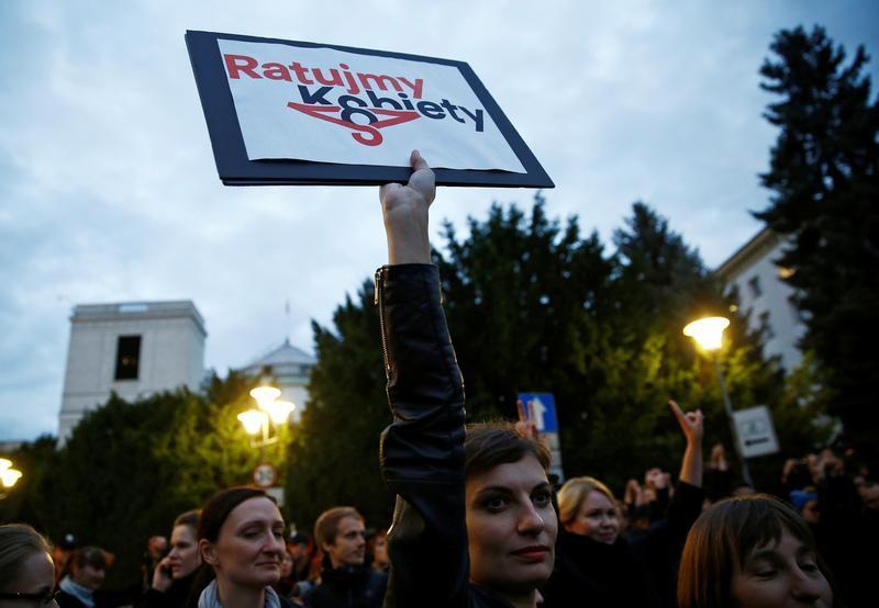 Woman holds a placard as she takes part in an abortion rights campaigners' demonstration in front of the Parliament in Warsaw, Poland September 22, 2016. The placard reads: "Let's save women".