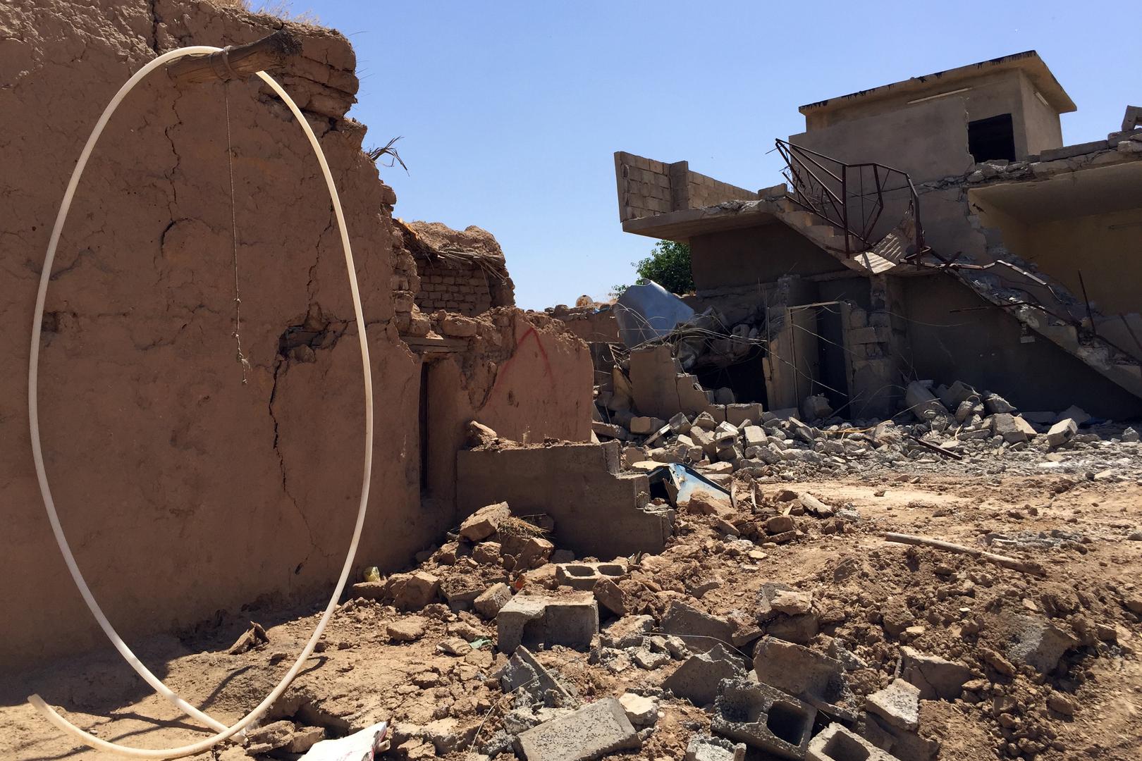 Destroyed houses in Qarah Tappah, with partial red “X” still visible, May 20, 2016. © 2016 Human Rights Watch