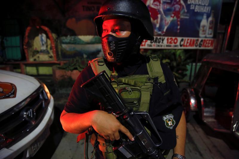 A member of the special police force takes position in Caloocan City, Metro Manila, Philippines early October 14, 2016.