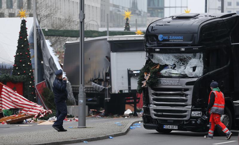 Police stand in front of the truck which plowed last night into a crowded Christmas market in the German capital Berlin, Germany, December 20, 2016.