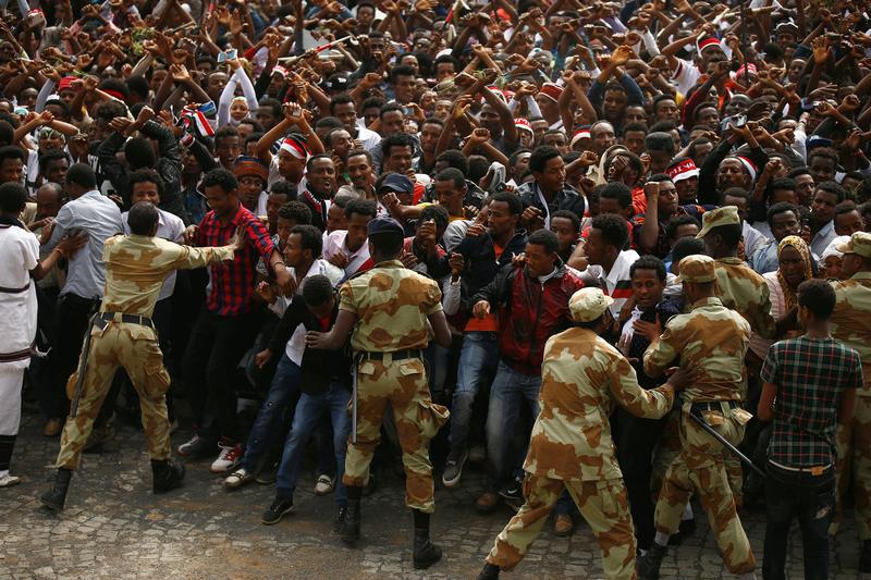 Ethiopian security hold back demonstrators chanting slogans during Irreecha, the thanksgiving festival of the Oromo people, in Bishoftu town, Oromia region, Ethiopia, October 2, 2016. 