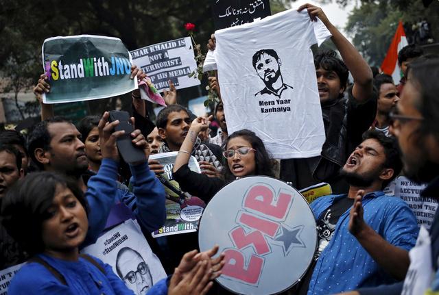 Demonstrators hold placards and a t-shirt featuring Kanhaiya Kumar during a protest demanding his release in New Delhi, India on February 18, 2016. 