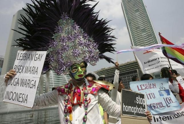 A demonstrator holds signs during an International Day Against Homophobia event in Jakarta, Indonesia on May 17, 2008.