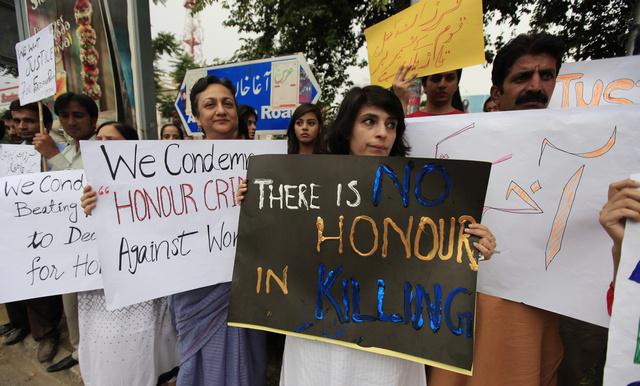 Members of civil society hold placards during a protest in Islamabad, Pakistan against a recent "honor" killing on May 29, 2014.