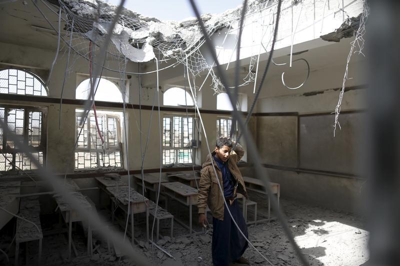 A boy stands in a classroom at his school after it was hit by a Saudi-led air strike in Yemen's capital Sanaa July 20, 2015.