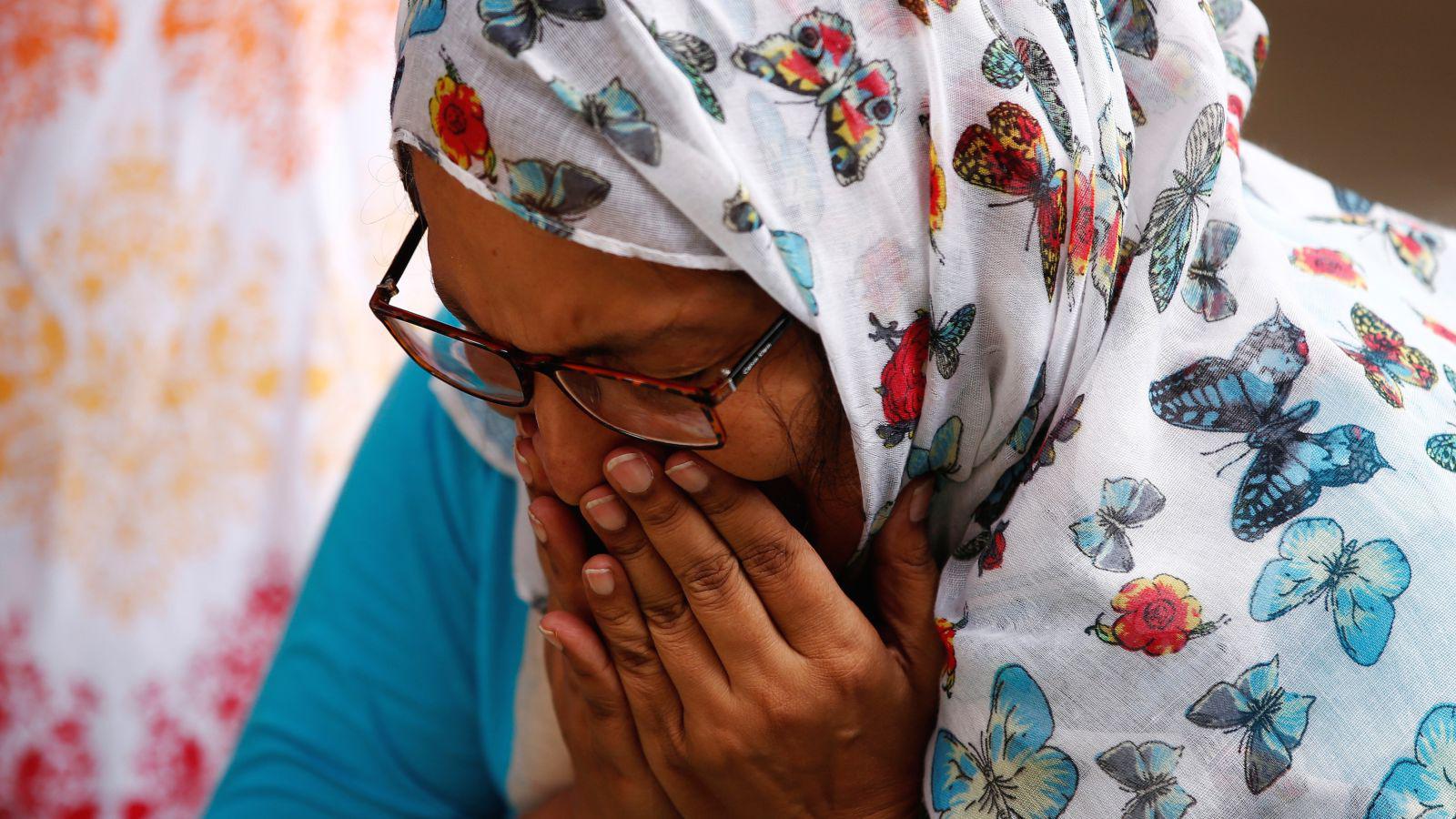 A woman mourns for the victims who were killed in the attack on the Holey Artisan Bakery and the O'Kitchen Restaurant, at a makeshift memorial near the attack site, in Dhaka, Bangladesh, July 5, 2016. 