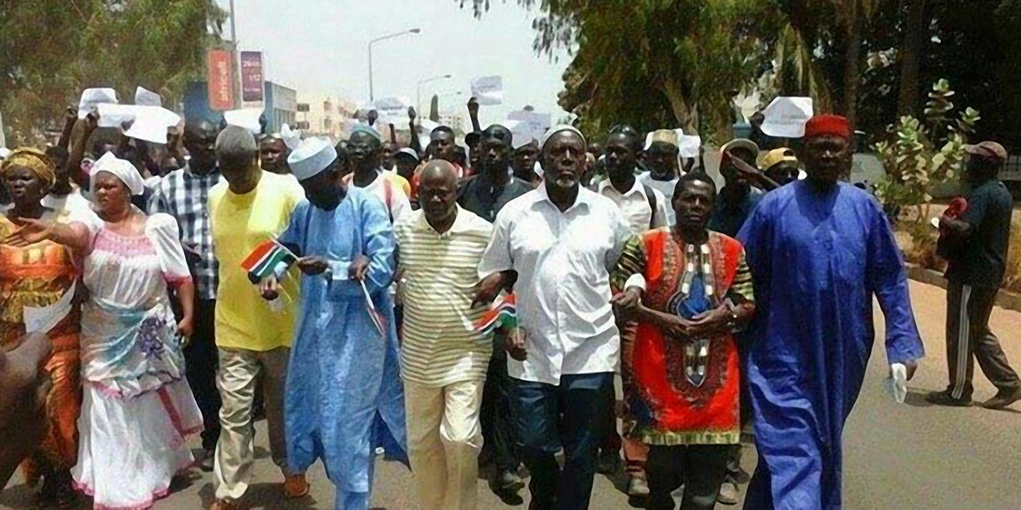 Protesters march in Banjul on April 16, 2016 following the death in custody of opposition activist Solo Sandeng.