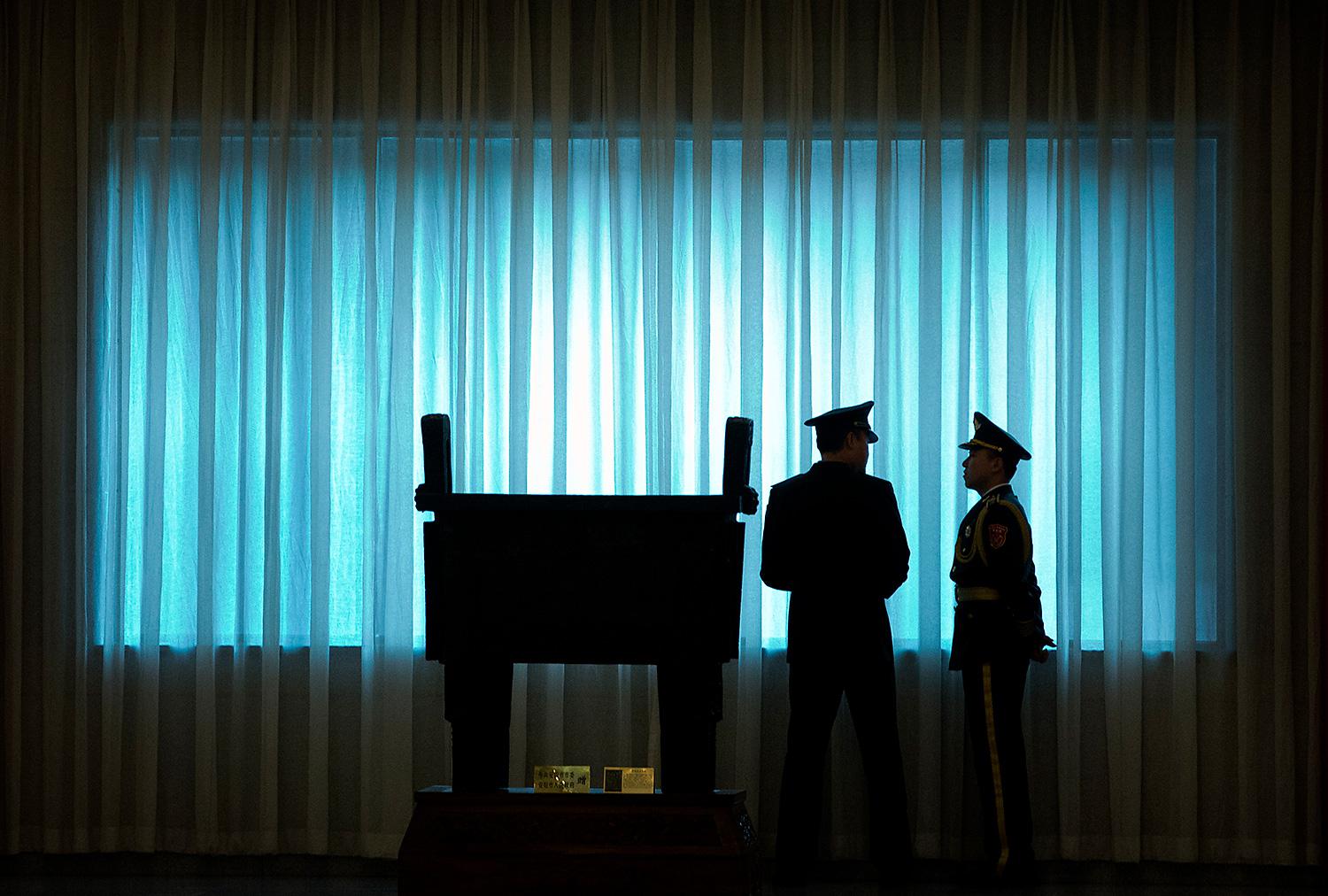 People’s Liberation Army officers stand in front of a window before a welcome ceremony for U.S. Army Chief of Staff General Mark Milley at the Bayi Building in Beijing, August 16, 2016.