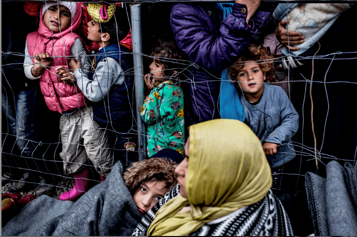 Families waiting for a bottle of water and a sandwich per person at a camp in Idomeni, Greece, March 2016.