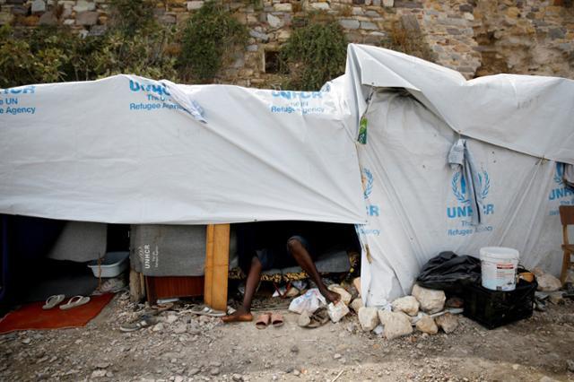 A man rests inside a tent at the Souda municipality-run refugee camp on the island of Chios.
