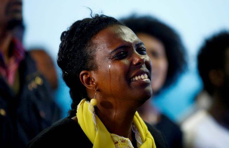 A woman cries as she attends a prayer session at Biftu Bole Lutheran Church during a prayer and candle ceremony for those who died in the town of Bishoftu during Ireecha, the thanksgiving festival for the Oromo people, Addis Ababa, Ethiopia, October 9, 20