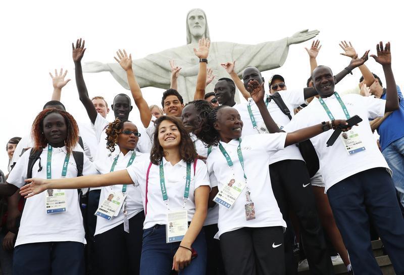 Members of the 2016 Olympic refugee team pose in front of Christ the Redeemer in advance of the Olympic games in Rio De Janeiro, Brazil on July 30, 2016.